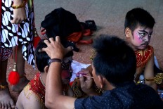 A boy has makeup put on before the performance. JP/Maksum Nur Fauzan
