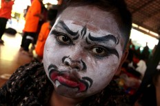 A boy is ready to perform after being dressed. JP/Maksum Nur Fauzan