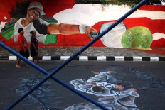  Tennis player Yayuk Basuki is one of the athletes pictured on the wall. JP/Maksum Nur Fauzan