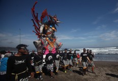 A statue of Garuda (the king of birds, which is also the vehicle mount of the Hindu god Vishnu) is also floated to the sea. JP/Boy T. Harjanto