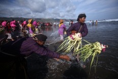 Villagers throw their offerings into the sea. JP/Boy T. Harjanto