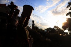 Getting to safety: Lombok residents take their belongings to a safer place after a series of earthquakes hit the island. JP/ Seto Wardhana