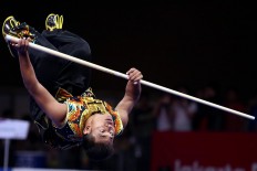 Upside down: Myanmar wushu athlete Thein Than flips during the 2018 Asian Games men’s nangun wushu competition. JP/ PJ Leo