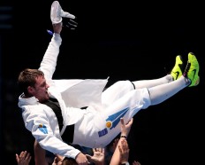 On top: Dmitriy Alexanin of Kazakhstan celebrates with his team after winning the men's individual epee fencing match against Park Sang-young from Korea.JP/ PJ Leo