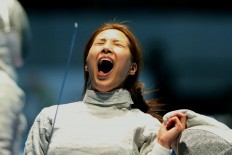 Elation: South Korea fencer Choi Soo-Yeon screams during the women's saber team semifinal match between South Korea and Japan at the 2018 Asian Games. South Korea won 45-25. JP/Seto Wardhana