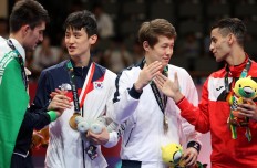 Masterclass: South Korea taekwondoin Lee Dae-hoon shakes hands with Iran’s Amir mohammad Bakhshikalhori after winning a gold medal in the men’s 68 kilogram taekwondo final in Jakarta. JP/PJ Leo