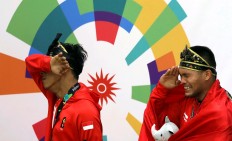 Pride of the nation: Indonesia martial artist Hendy (Left) and his partner Yola Primadona Jampil cry tears of joy after winning gold in the pencak silat men's doubles final. JP/PJ Leo