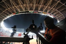 A photojournalist sets up his camera in Gelora Bung Karno (GBK) main stadium in Jakarta. JP/Seto Wardhana