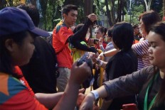 Officers scan barcodes on visitors’ tickets at entrance gate to Asian Fest in Jakarta. JP/Umair Rizaludin