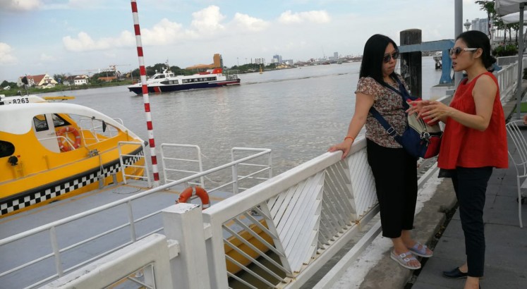 Wading through Saigon River on water bus