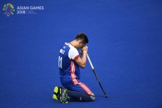  Hong Kong men’s hockey player Ka Chun Chan kneels before a preliminary hockey game against South Korea at the 2018 Asian Games at the Hockey Field in the Gelora Bung Karno (GBK) sport complex in Jakarta on Monday, Aug. 20. Inasgoc via Antara/ Dhoni Setiawan