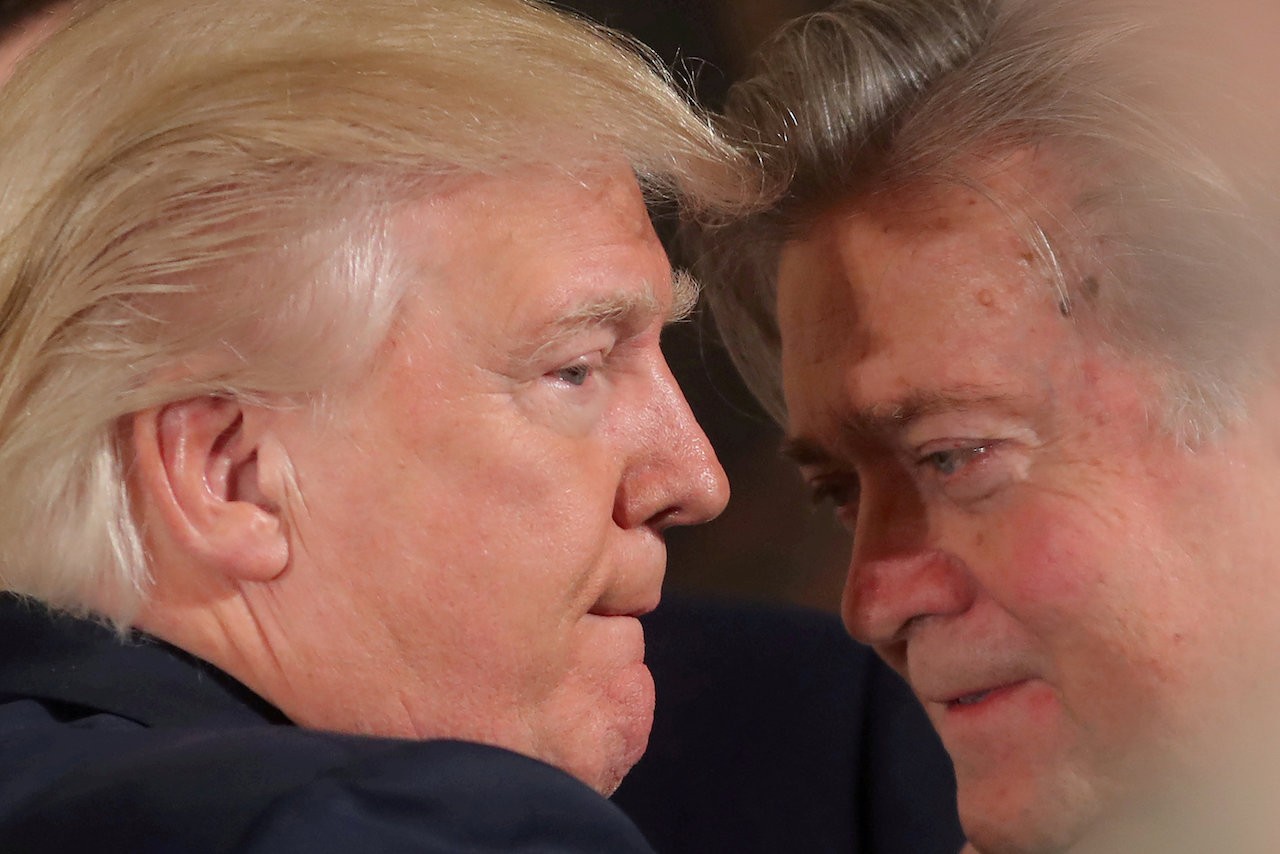 U.S. President Donald Trump talks to chief strategist Steve Bannon during a swearing in ceremony for senior staff at the White House in Washington, U.S. January 22, 2017. REUTERS/Carlos Barria