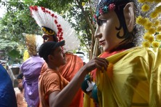 Properly dressed: A craftsman dresses ondel-ondel figures in colorful costumes. JP/David Caessarre