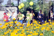 Beautiful vista: Runners make their way through an agricultural field during the 2018 Maybank Bali Marathon on Sept. 9 in Gianyar, Bali. The race track also covers Klungkung village, with its beautiful rice fields and plantations, providing perfect backdrops where runners can watch the sun rise.
