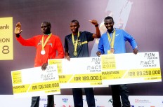 Kenya’s fastest gentlemen: Winners of the 2018 Maybank Bali Marathon’s men’s full marathon category on Sept. 9 in Gianyar, Bali, all of whom come from Kenya, pose together for a photograph. The first-place winner of the event is Cosmas Matolo Muteti (center), followed by runner-up Kiprop Tonui (right) and third-place winner Cossmas Kimutai (left).