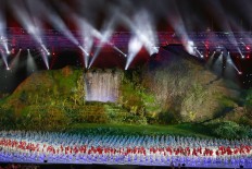 Indonesian athletes walk onto the stage during the opening ceremony of the 2018 Asian Games at Bung Karno Stadium. JP/PJ Leo