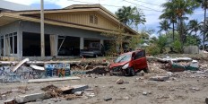 Damaged cars are seen in front of a broken house in Palu on Sept. 29 after an earthquake hit the area. JP/ Ruslan Sangaji