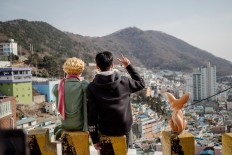 A tourist takes a picture with The Little Prince character in Gamcheon. JP/Anggara Mahendra
