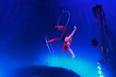 Upside down: A performer hangs upside down while spinning a hula hoop with her leg. JP/Vellen Augustine