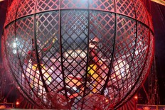 Don't try this: The crazy globe features two motorcyclists riding at high speed inside an iron sphere. JP/Vellen Augustine