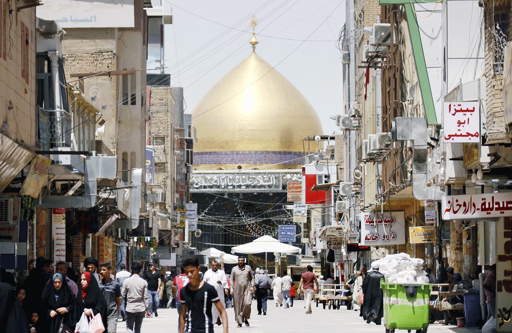 Bustling: Iraqis walk near the Immam Ali shrine in the holy city of Najaf, 150 kilometers south of Baghdad. 