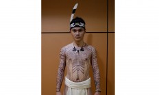 A male dancer wearing a Dayak traditional costume shows off his tattoos by artist Aman Durga Sipatiti at the Teater Jakarta. JP/Wienda Parwitasari