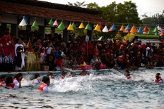 Villagers dive into the water, creating sounds from splashing the water, which is locally known as ciblon. JP/Magnus Hendratmo