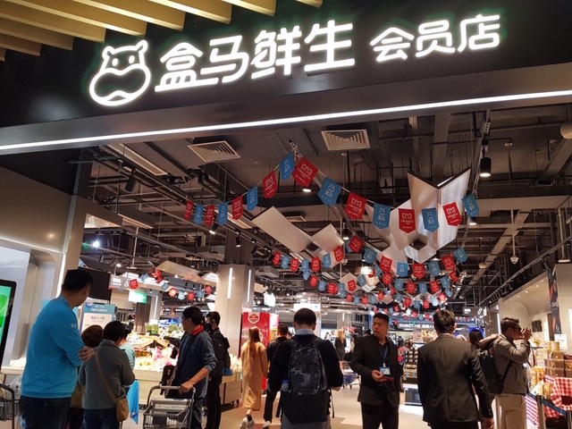 People are pictured shopping at Hema Supermarket, part of Alibaba Group, in Shanghai, China. In China, Hema is a digitized retail store that allow consumers to buy food, eat in or order home delivery.