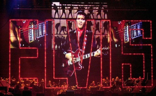 In this file photo taken on August 16, 2002, Elvis Presley sings via projection screen at the Elvis Presley 25th Anniversary Concert in Memphis, Tennessee. Music legend Elvis Presley, baseball great Babe Ruth and late Supreme Court justice Antonin Scalia are among seven people who will be honored with the Presidential Medal of Freedom, the White House said on November 10, 2018. The award is the country's highest civilian honor, and recognizes 