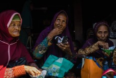 Elders enjoy their food – which has been prayed over and blessed – after the ritual. JP/Anggertimur Lanang Tinarbuko