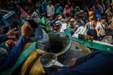  Courtiers from the Surakarta Hadiningrat palace pour sacred water into the Enceh Kyai Mendung from the Kingdom of Ngerum (Turkey). JP/Anggertimur Lanang Tinarbuko