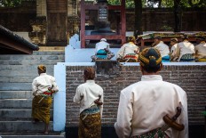 Courtiers, dressed in traditional Javanese costumes, prepare themselves by sitting next to each other and starting a prayer before the Nguras Enceh ritual begins. JP/Anggertimur Lanang Tinarbuko