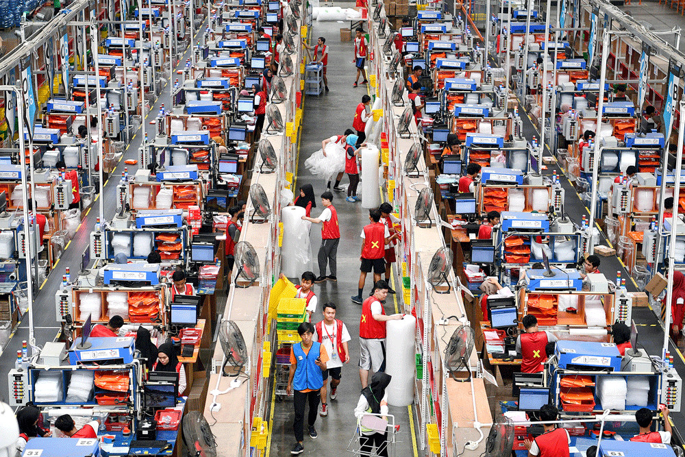 Lazada employees pack goods for dispatch at the online shop’s warehouse in Depok, West Java.
