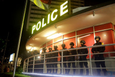 On guard: Police personnel are stationed at the Hotel Indonesia traffic circle to secure the New Year's festivities on Monday. JP/Wendra Ajistyatama