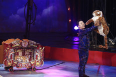 Modernizing performance: An Oriental Circus Indonesia performer showcases a Sumatran tiger plush toy. The circus has decided to stop using live animals as part of its 50-year anniversary celebration. JP/Dhoni Setiawan