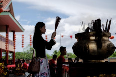 Give thanks: A woman prays during a Chinese New Year celebration at Satya Dharma temple in Benoa Bali. JP/Anggara Mahendra