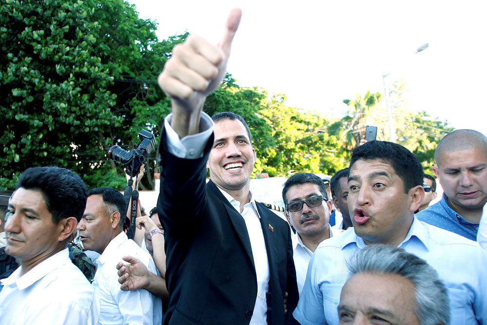 Home soon: Venezuelan opposition leader Juan Guaido (center), who many nations have recognized as the country’s rightful interim ruler, gestures after a meeting with Ecuador President Lenin Moreno in Salinas, Ecuador, on Saturday. He said he would return home after a visit to Ecuador and called for new protests next week against President Nicolas Maduro, whose government had banned him from traveling abroad.