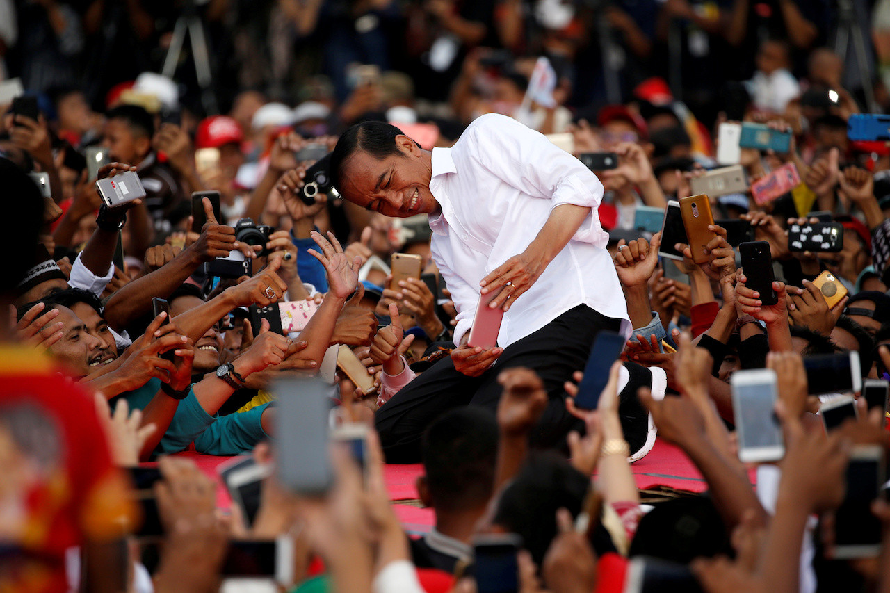 A throng of supporters take pictures of President Joko "Jokowi" Widodo during his reelection campaign in Serang, Banten in 2019.