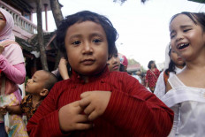 Children from a nature club participate in the parade with their parents and relatives. JP/Syamsul Huda M.Suhari