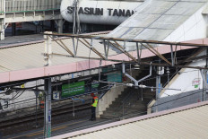A security guards watches over an empty Tanah Abang train station. JP/Dhoni Setiawan