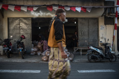 Tobacco abounds on this small street in Parakan, stacked high inside of warehouses while awaiting purchase. JP/Dottie Bond