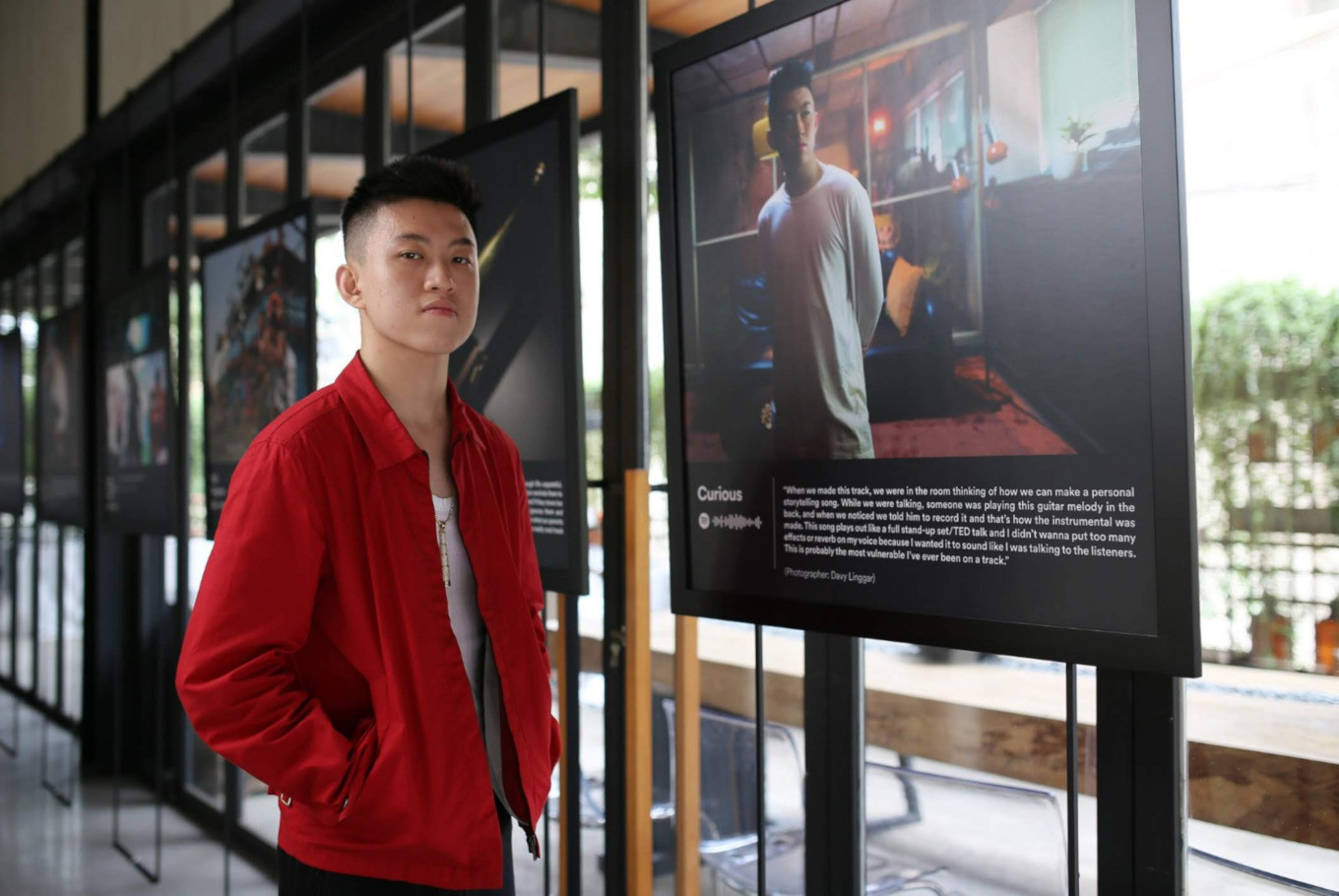 Rich Brian poses beside one of the photos displayed at 'The Sailor Exhibition'. The event was held until Aug. 10, at Gudang Gambar in South Jakarta. 
