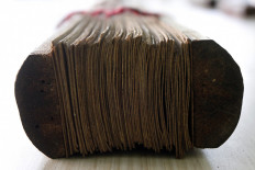 Palm leaf manuscripts are usually put together in bundles using bamboo clips. JP/Arya Dipa
