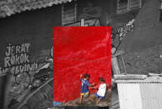 Two children play soccer against the background of a red wall. JP/Boy T Harjanto