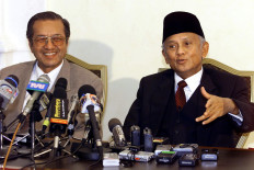 Indonesian President B. J. Habibie (R) gestures as he answers a question while Malaysian Prime Minister Mahathir Mohamad looks on, during a press conference at the latter's office in Putrajaya 25 August 1999. Habibie, who is on a short visit to Malaysia, told reporters that he was anxious to know the outcome of the investigations into the Bank of Bali scandal. AFP/Jimin Lai