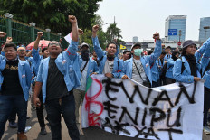 Indonesian students hold a protest against the government's proposed change in its criminal code laws and plans to weaken the anti-corruption commission, outside the parliament building in Jakarta on September 24, 2019. - Indonesia's President Joko Widodo on September 20 called for a delay in passing a new criminal law overhaul that would outlaw gay and pre-marital sex after the controversial plan sparked a public outcry. Updating Indonesia's criminal code -- which stretches back to the Dutch colonial era -- has been debated for decades and appeared set to pass in 2018 before it fizzled. AFP/Adek Berry