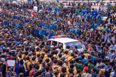 Ambulance vans pick up injured and exhausted students in front of the House of Representatives building in Senayan, Jakarta on Sept. 24. Police shot tear gas and water at the students to disperse the rally. JP/Anggie Angela