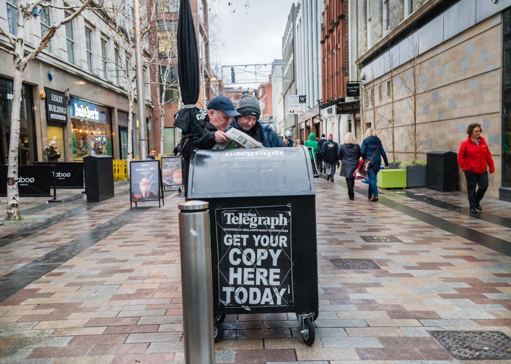 Two men read a newspaper at Belfast city center. JP/Okky Ardya