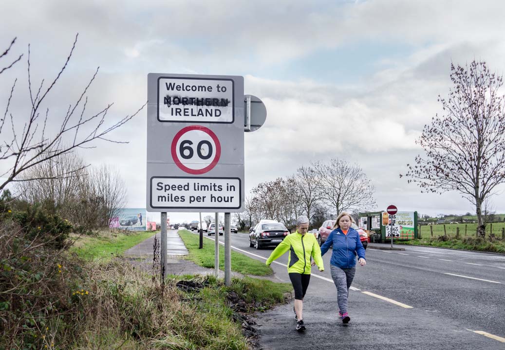 Two women walk past the border between Northern Ireland and the Republic of Ireland on Buncrana Road in the western suburbs of Derry/Londonderry. JP/Okky Ardya