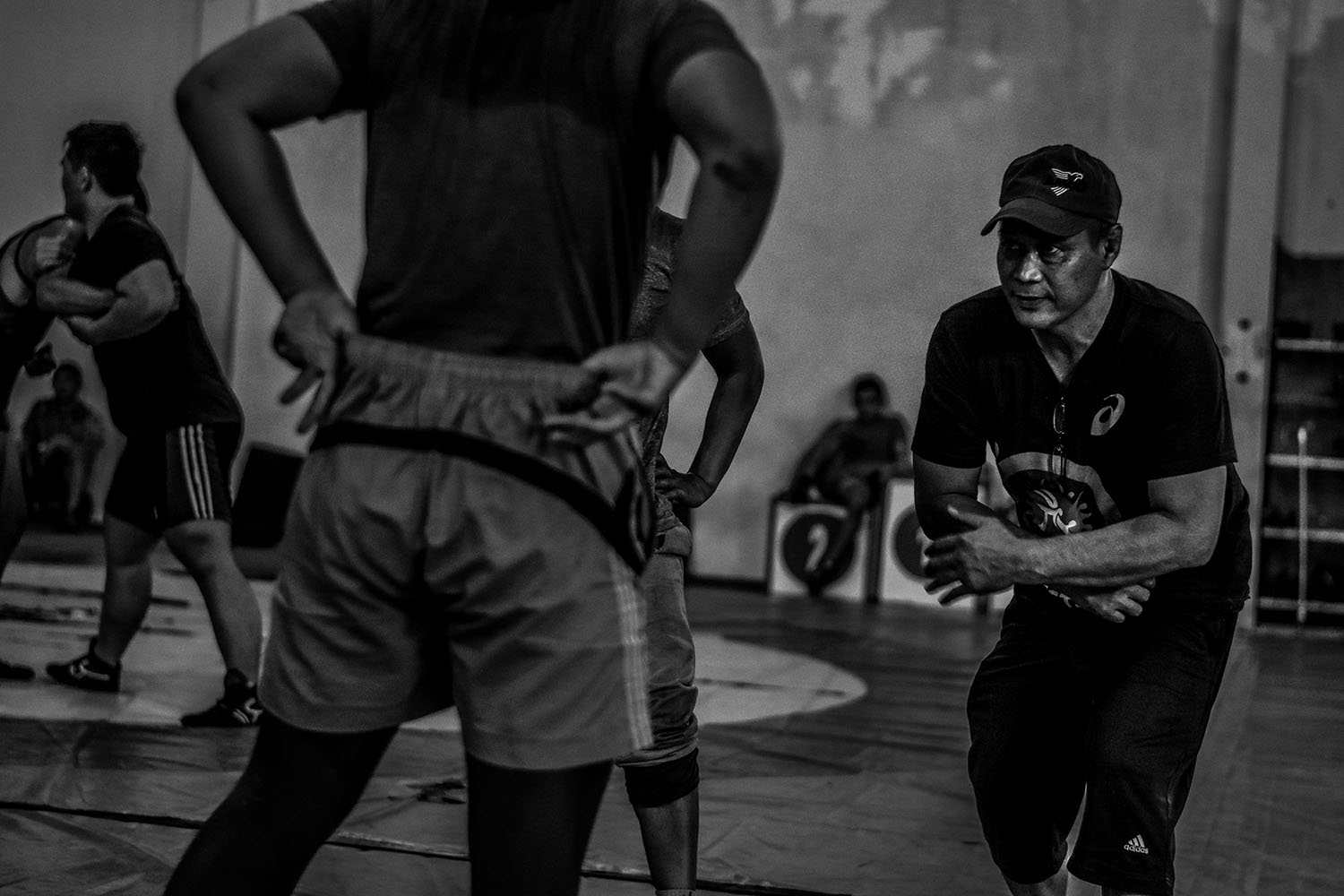 Fathur Rachman (right), 51, lectures the young athletes at the camp. JP/Aman Rochman